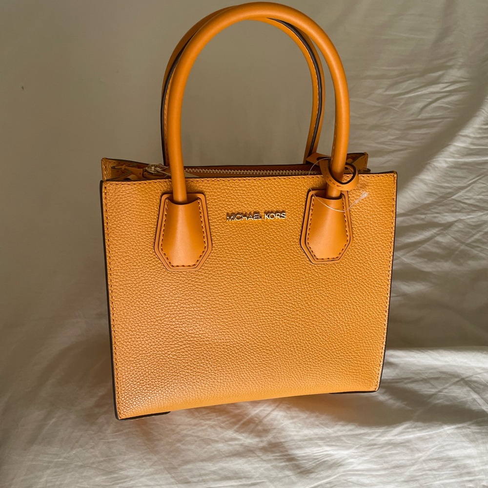 Beautiful orange Michael Kors bag! Never been used. Comes with bag.